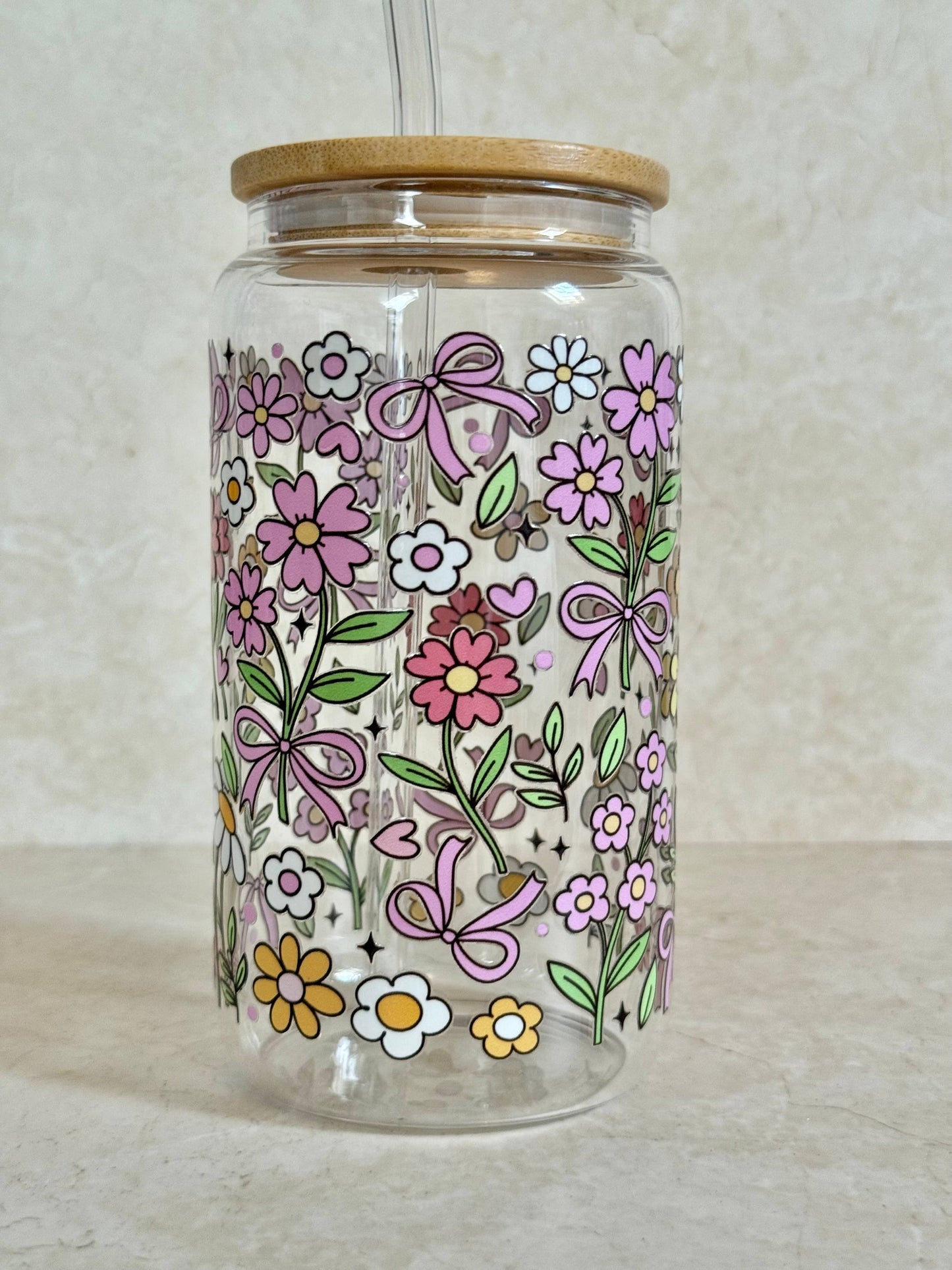 Glasbecher mit Blumenumriss, Bambusdeckel und Glasstrohhalm